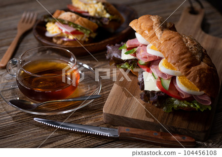 Egg, cheese, ham, baguette sandwich with plenty of vegetables 104456108