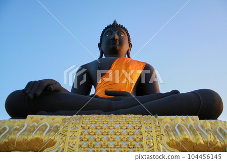 Big black Buddha statue with blue sky 104456145