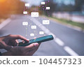 Man hand using smart phone and email icon flying at street abstract background. Copy space travel adventure lifestyle and business economic concept. Vintage tone effect color style 104457323