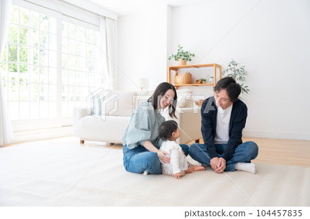 A smiling family of three spending time at home (family, childcare, childcare, baby) A smiling family of three spending time at home (family, childcare, childcare, baby) 104457835