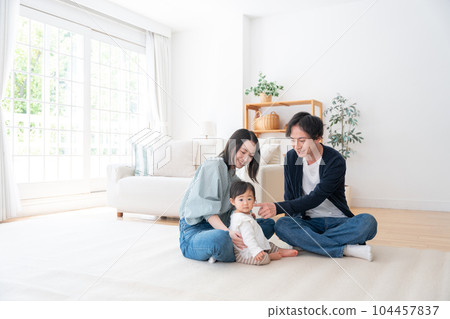A smiling family of three spending time at home (family, childcare, childcare, baby) A smiling family of three spending time at home (family, childcare, childcare, baby) 104457837