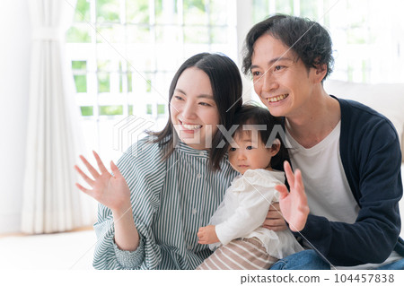 A smiling family of three spending time at home (family, childcare, childcare, baby) A smiling family of three spending time at home (family, childcare, childcare, baby) 104457838