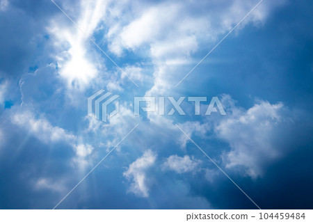 Sunbeam through the cloud on blue sky Sunbeam through the cloud on blue sky 104459484