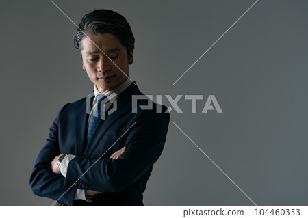 A man with his arms folded Business A man with his arms folded Business 104460353