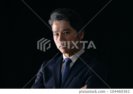 A man with his arms folded Business A man with his arms folded Business 104460361