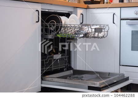 A lot of dirty dishes in the dishwasher. Helping the hostess, economy and ecology. Cleaning in the kitchen 104462288