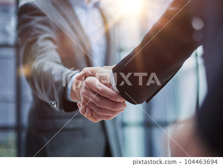 Two diverse professional business men executive leaders shaking hands at office meeting Two diverse professional business men executive leaders shaking hands at office meeting 104463694