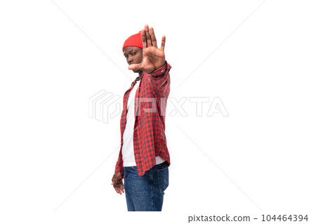 handsome smart black man in casual plaid shirt waving his hand on white background with copy space handsome smart black man in casual plaid shirt waving his hand on white background with copy space 104464394
