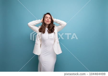 fashion business young lady in white dress and jacket posing on studio background with copyspace 104464499