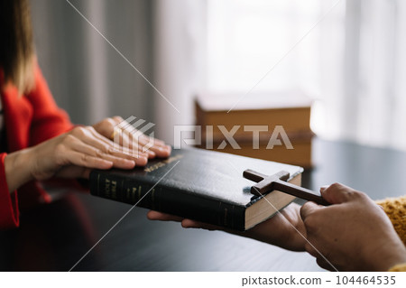 Asian men and women hands praying to god with the bible. Pray for god blessing. Religious beliefs Christian life crisis prayer to god. Asian men and women hands praying to god with the bible. Pray for god blessing. Religious beliefs Christian life crisis prayer to god. 104464535