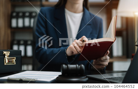 Serious pensive lawyer working at desk in office. 104464552