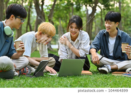 Image of university students talking and laughing together in campus. Friendship, youth lifestyle and education concept Image of university students talking and laughing together in campus. Friendship, youth lifestyle and education concept 104464899