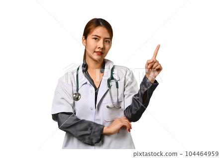 Portrait of female doctor dressed in white coat with stethoscope and pointing finger overhead isolated on white background Portrait of female doctor dressed in white coat with stethoscope and pointing finger overhead isolated on white background 104464959