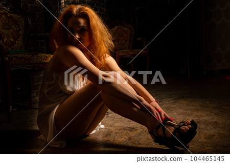 naked woman in a semi transparent white dress in the studio 104465145