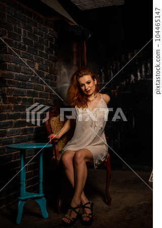 naked woman in a semi transparent white dress in the studio 104465147