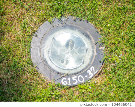 Outdoor lighting device built into the ground. Lantern on the ground. Modern lighting system 104466041