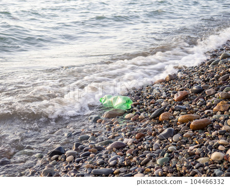 A green plastic bottle washed ashore. . Plastic container on the beach A green plastic bottle washed ashore. . Plastic container on the beach 104466332