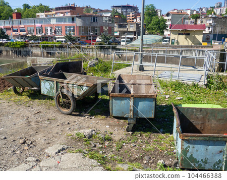 Old rusty wheelbarrows. Scavenger equipment. Old trash. Old rusty wheelbarrows. Scavenger equipment. Old trash. 104466388