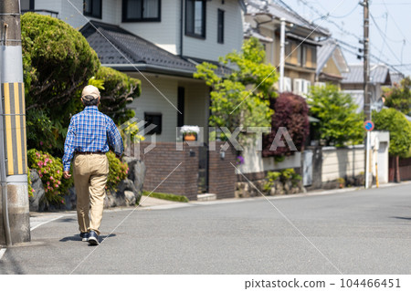 Back view of a senior man walking in the neighborhood Back view of a senior man walking in the neighborhood 104466451