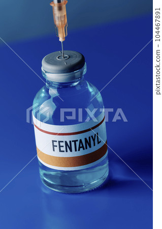 syringe in a simulated vial of fentanyl syringe in a simulated vial of fentanyl 104467891