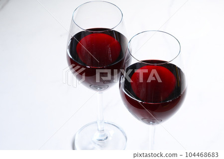 Two wine glasses filled with red wine Two wine glasses filled with red wine 104468683