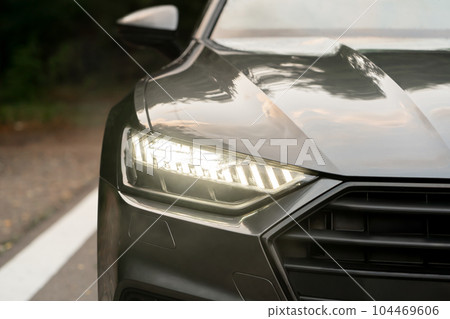 The lighted headlight of a modern car The lighted headlight of a modern car 104469606