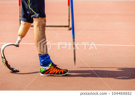 leg on prosthesis male athlete with spear at athletics championships, summer para sports games 104469882