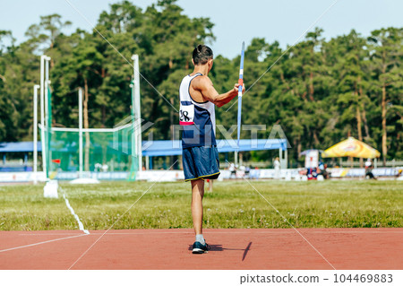 para athlete without leg with crutch javelin throw at athletics championships, summer sports games 104469883