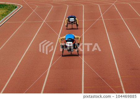 two athletes in wheelchair racing race track stadium in para athletics championship, summer sports games 104469885