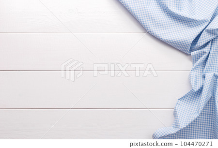 White wooden table with blue checkered table cloth 104470271
