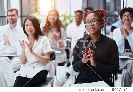 Audience Applauding a Great Speaker at Business convention and Presentation Audience Applauding a Great Speaker at Business convention and Presentation 104471541