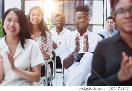 Selective focus of young businesswoman applauding together with interracial colleagues during seminar, banner Selective focus of young businesswoman applauding together with interracial colleagues during seminar, banner 104471542