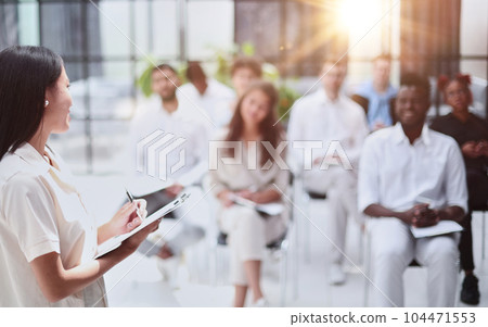 Selective focus of lecturer talking to audience during seminar in conference room Selective focus of lecturer talking to audience during seminar in conference room 104471553