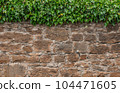 Old stone wall to be used as a background or texture. Ancient wall from old city. 104471605