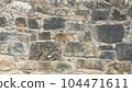 Old stone wall to be used as a background or texture. Ancient wall from old city. 104471611