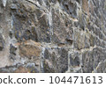 Old stone wall to be used as a background or texture. Ancient wall from old city. 104471613
