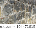 Old stone wall to be used as a background or texture. Ancient wall from old city. 104471615