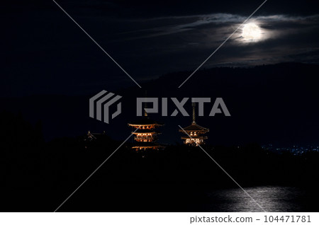 Night view of Yakushiji Temple and the autumn moon peeking through the clouds Night view of Yakushiji Temple and the autumn moon peeking through the clouds 104471781