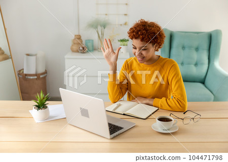 African american girl using laptop computer having video chat at home. Young woman having virtual meeting online chat video call conference. Work learning from home, remote teacher African american girl using laptop computer having video chat at home. Young woman having virtual meeting online chat video call conference. Work learning from home, remote teacher 104471798