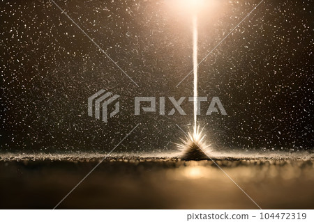 Abstract lighting blasting explosion into the ice surface at the icy ground when snow, low light background. Abstract lighting blasting explosion into the ice surface at the icy ground when snow, low light background. 104472319
