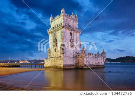 Belem Tower or Tower of St Vincent - famous tourist landmark of Lisboa and tourism attraction - on the bank of the Tagus River Tejo after sunset in dusk twilight with dramatic sky. Lisbon, Portugal Belem Tower or Tower of St Vincent - famous tourist landmark of Lisboa and tourism attraction - on the bank of the Tagus River Tejo after sunset in dusk twilight with dramatic sky. Lisbon, Portugal 104472786