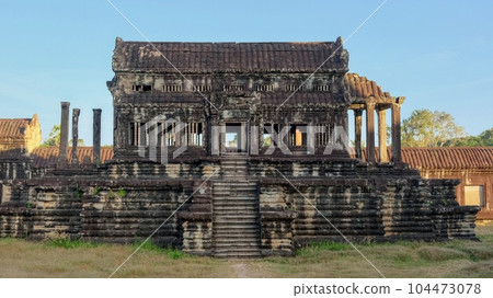 An antiquated Khmer structure lies abandoned amidst the ruins of the medieval city of Angkor, its silent presence evoking an air of mystique. An antiquated Khmer structure lies abandoned amidst the ruins of the medieval city of Angkor, its silent presence evoking an air of mystique. 104473078