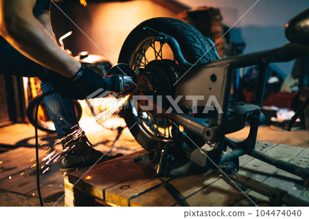 Motorcycle repair. Disassembled motorcycle. Fixing motorcycle standing in repair shop. Instruments. Motorcycle repair. Disassembled motorcycle. Fixing motorcycle standing in repair shop. Instruments. 104474040