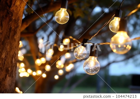 Blurred photo of camping tents with lighting decoration at night Blurred photo of camping tents with lighting decoration at night 104474213