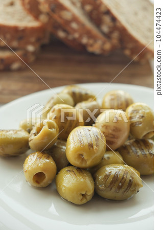 Turkish Grilled olives in a bowl  104474423