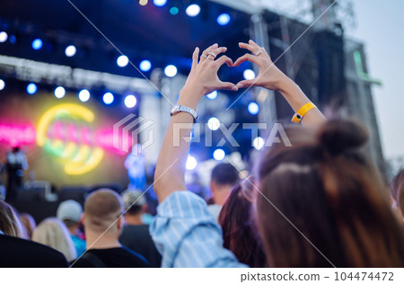 Using smartphone in public event, live music festival. Youth, party, vacation concept. Using smartphone in public event, live music festival. Youth, party, vacation concept. 104474472