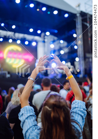 Using smartphone in public event, live music festival. Youth, party, vacation concept. Using smartphone in public event, live music festival. Youth, party, vacation concept. 104474473