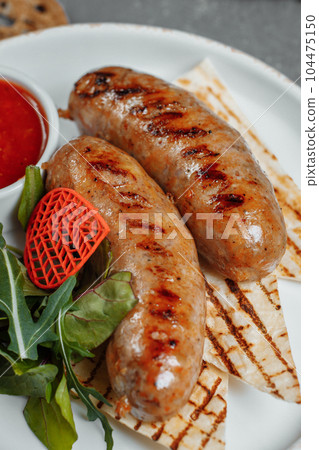 Grilled tasty bratwurst sausages on the plate Grilled tasty bratwurst sausages on the plate 104475150