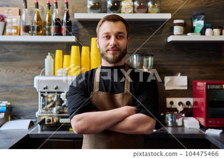 Young confident male coffee shop owner with crossed arms 104475466
