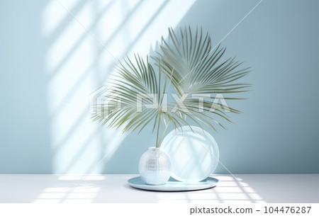Light blue wall with shade and plant on the floor in a vase 104476287